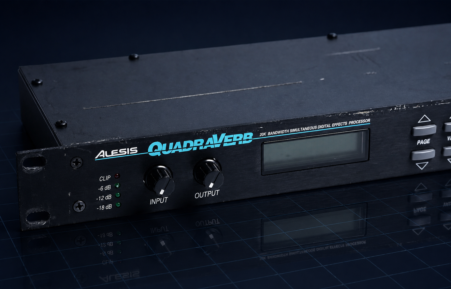 Alesis QuadraVerb 1U rack-mount digital effects processor, showing the front panel with LCD screen, Input and Output knobs, and clip LEDs